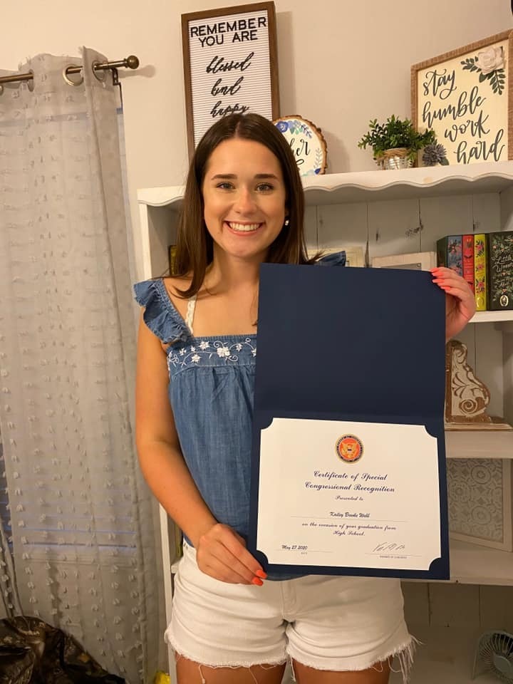Photo of Kailey Webb with her certificate of congressional recognition.